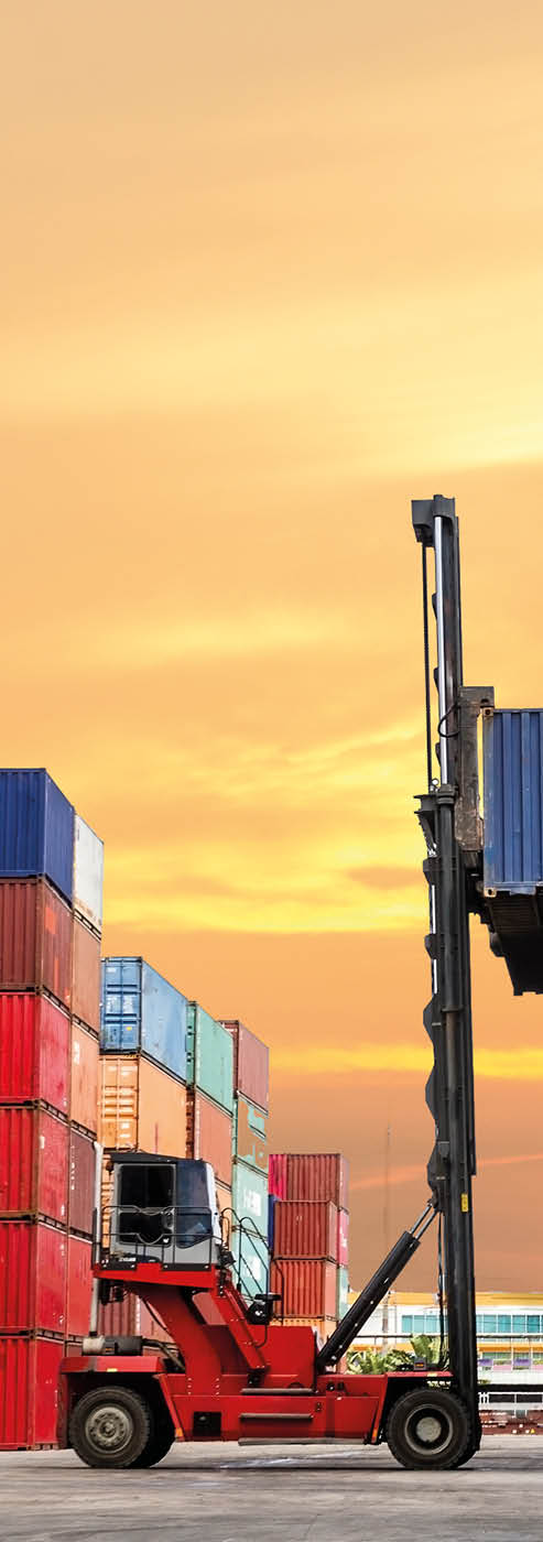Crane lifting up container in yard